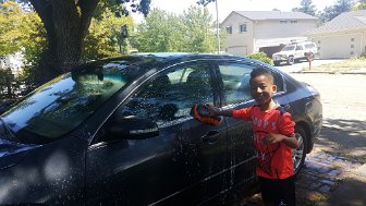 2019 front yard 06 29 11 35 09 01 Al washing the car